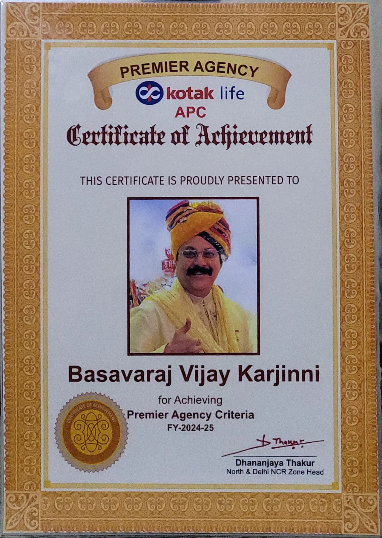 Kotak Life APC Certificate of Achievement presented to Basavaraj Vijay Karjinni for achieving Premier Agency Criteria in FY 2024-25, signed by Dhananjaya Thakur, North & Delhi NCR Zone Head.
